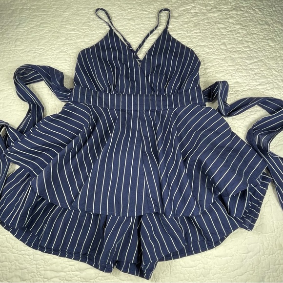 🔥Lulus Ruffle & Flow Black Striped Backless Ruffle
Romper Blue White - Picture 11 of 16